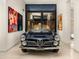 Classic convertible car displayed in a modern garage with artwork and natural light at 4900 E Arroyo Verde Dr, Paradise Valley, AZ 85253