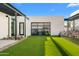 Stylish home exterior showcasing a garage and manicured artificial lawn at 4900 E Arroyo Verde Dr, Paradise Valley, AZ 85253