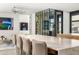 Modern kitchen with marble island, comfortable seating and a glass-enclosed wine storage at 4900 E Arroyo Verde Dr, Paradise Valley, AZ 85253