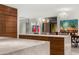 Open kitchen with marble countertops, walnut cabinets, and modern light fixtures at 4900 E Arroyo Verde Dr, Paradise Valley, AZ 85253