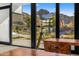 Bright living room featuring a modern telescope and stunning mountain views through expansive windows at 4900 E Arroyo Verde Dr, Paradise Valley, AZ 85253