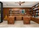Home office features wooden accents, built-in shelving, and a sleek ceiling fan at 4900 E Arroyo Verde Dr, Paradise Valley, AZ 85253