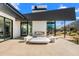 Beautiful outdoor patio area featuring modern seating, a fireplace, and mountain views, creating a serene and stylish space at 4900 E Arroyo Verde Dr, Paradise Valley, AZ 85253