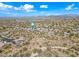 Aerial view of neighborhood featuring desert landscaping, tile roofs, blue skies and mountain views at 5323 E Thunder Hawk E Rd, Cave Creek, AZ 85331