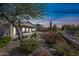 The backyard has desert landscaping, covered patio, gravel accents and mature shade trees at 5323 E Thunder Hawk E Rd, Cave Creek, AZ 85331