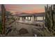 Home's landscaped backyard features desert plants, an extended covered patio and gravel accents at 5323 E Thunder Hawk E Rd, Cave Creek, AZ 85331