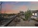 Well landscaped backyard with desert plants, custom rock and gravel, all enclosed with a black wrought iron fence at 5323 E Thunder Hawk E Rd, Cave Creek, AZ 85331