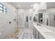 Elegant bathroom with dual sinks, a walk-in shower, and a tile accent wall at 5323 E Thunder Hawk E Rd, Cave Creek, AZ 85331