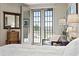 Bright bedroom with white linens, French doors to the backyard, and seating area at 5323 E Thunder Hawk E Rd, Cave Creek, AZ 85331