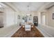 Dining room with white and beige color scheme, decorated with a modern chandelier and an area rug at 5323 E Thunder Hawk E Rd, Cave Creek, AZ 85331