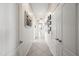 Long hallway with tiled floors, neutral walls, multiple doors and decorative picture frames at 5323 E Thunder Hawk E Rd, Cave Creek, AZ 85331