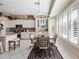 Kitchen with an adjacent eat-in breakfast nook area, white cabinets, stainless steel appliances and large windows at 5323 E Thunder Hawk E Rd, Cave Creek, AZ 85331