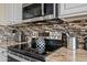 Modern kitchen with stainless steel appliances and a decorative backsplash behind the stovetop at 5323 E Thunder Hawk E Rd, Cave Creek, AZ 85331