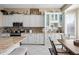 Bright kitchen featuring white cabinets, tiled backsplash, stainless steel appliances, and a peninsula island at 5323 E Thunder Hawk E Rd, Cave Creek, AZ 85331