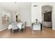 Bright dining room with stylish chandelier, long table set for eight, and decorative console table at 5456 E Woodridge Dr, Scottsdale, AZ 85254