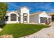 Charming home featuring a well-maintained lawn, white stucco walls, and a tiled roof, perfect curb appeal at 5456 E Woodridge Dr, Scottsdale, AZ 85254