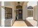 Inviting front entry with a black door, decorative wreath, and charming landscaping at 5456 E Woodridge Dr, Scottsdale, AZ 85254