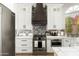Modern kitchen featuring stainless steel appliances, white cabinets, and a decorative backsplash at 5456 E Woodridge Dr, Scottsdale, AZ 85254