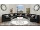 Elegant living room featuring a curved gray sofa, decorative pillows, and round glass coffee table at 5456 E Woodridge Dr, Scottsdale, AZ 85254