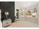 Bright primary bedroom featuring a modern light fixture, geometric wall accent, and large windows offering natural light at 5456 E Woodridge Dr, Scottsdale, AZ 85254