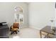 Home office featuring a bright window with natural light, a work chair, and dark wood desk at 5456 E Woodridge Dr, Scottsdale, AZ 85254