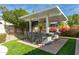 Modern outdoor bar area with built-in grill, bar seating, and outdoor TVs for entertaining guests at 5456 E Woodridge Dr, Scottsdale, AZ 85254