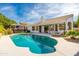 Private backyard oasis with a sparkling pool, covered patio, lounge seating, and manicured landscaping at 5456 E Woodridge Dr, Scottsdale, AZ 85254