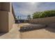 Open backyard featuring a brick wall, pavers, and side access to the home at 6010 E Greenway Ln, Scottsdale, AZ 85254