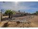 Spacious backyard with desert landscaping, rock features, and a covered patio at 6010 E Greenway Ln, Scottsdale, AZ 85254
