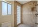 Modern bathroom with a walk-in shower boasting glass block detail, updated fixtures and neutral tile at 6010 E Greenway Ln, Scottsdale, AZ 85254