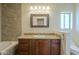 Updated bathroom features granite countertops, custom cabinets, and a decorative mirror and vanity lighting at 6010 E Greenway Ln, Scottsdale, AZ 85254