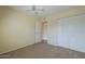 Neutral bedroom with carpet, ceiling fan, closet, and doorway to the en suite at 6010 E Greenway Ln, Scottsdale, AZ 85254
