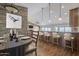 Open-concept dining and kitchen area with stone accent wall and breakfast bar at 6010 E Greenway Ln, Scottsdale, AZ 85254