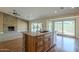 Kitchen island with stone accents, stainless steel sink, and ample countertop space in an open-concept home at 6010 E Greenway Ln, Scottsdale, AZ 85254