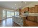 Kitchen island with stone accents, stainless steel sink, and pendant lighting, with backyard views at 6010 E Greenway Ln, Scottsdale, AZ 85254