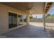 Covered patio with ceiling fan and backyard access through sliding glass doors at 6010 E Greenway Ln, Scottsdale, AZ 85254