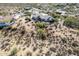 Aerial view of a desert home surrounded by lush desert landscaping and desert vegetation at 6404 S Lazy Ln, Gold Canyon, AZ 85118