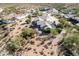 Aerial view of a desert home with beige tile roof surrounded by lush desert landscaping at 6404 S Lazy Ln, Gold Canyon, AZ 85118