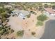 Aerial view of a desert home with a circular driveway, desert landscaping, and beige tile roof at 6404 S Lazy Ln, Gold Canyon, AZ 85118