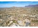 Expansive aerial view of a desert community with scenic mountain views in the distance at 6404 S Lazy Ln, Gold Canyon, AZ 85118