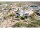 Stunning aerial view of a desert home with a three-car garage and beautiful landscaping at 6404 S Lazy Ln, Gold Canyon, AZ 85118