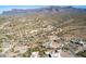 Panoramic aerial view of a desert landscape featuring luxury homes and stunning mountain vistas at 6404 S Lazy Ln, Gold Canyon, AZ 85118