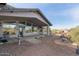 Inviting back patio with mature landscaping for tranquil outdoor enjoyment overlooking desert scenery at 6404 S Lazy Ln, Gold Canyon, AZ 85118