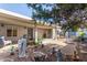 Charming backyard with a covered patio and a well maintained landscape featuring desert plants and decor at 6404 S Lazy Ln, Gold Canyon, AZ 85118