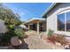 Private backyard featuring a covered patio and thoughtfully landscaped gravel area with colorful plants at 6404 S Lazy Ln, Gold Canyon, AZ 85118