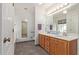 Well-lit bathroom features a dual sink vanity with a large mirror, and easy access shower at 6404 S Lazy Ln, Gold Canyon, AZ 85118