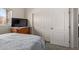 This bright bedroom features a large TV, and a wardrobe closet at 6404 S Lazy Ln, Gold Canyon, AZ 85118