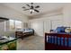 Bright bedroom featuring a ceiling fan, dual beds, large windows, and spacious closets at 6404 S Lazy Ln, Gold Canyon, AZ 85118
