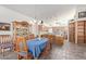 Open dining area featuring a wooden hutch, chandelier, and view of the spacious kitchen at 6404 S Lazy Ln, Gold Canyon, AZ 85118