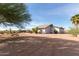 Beautiful single-story desert home with mature landscaping, gravel yard, and blue skies at 6404 S Lazy Ln, Gold Canyon, AZ 85118